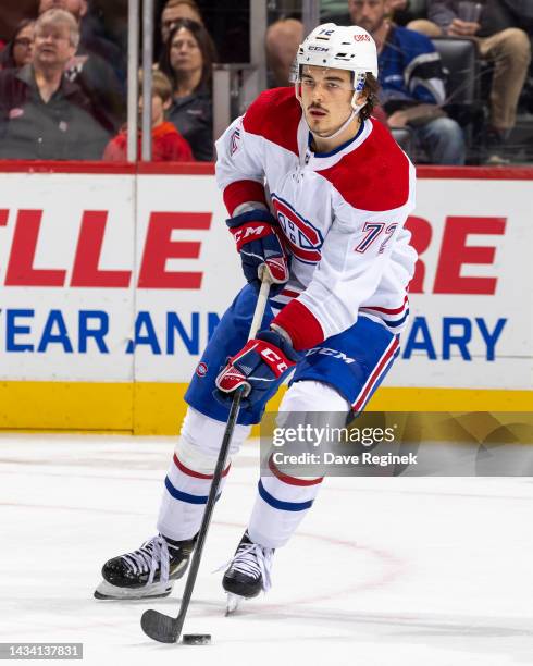 Arber Xhekaj of the Montreal Canadiens skates up ice with the puck against the Detroit Red Wings during an NHL game at Little Caesars Arena on...