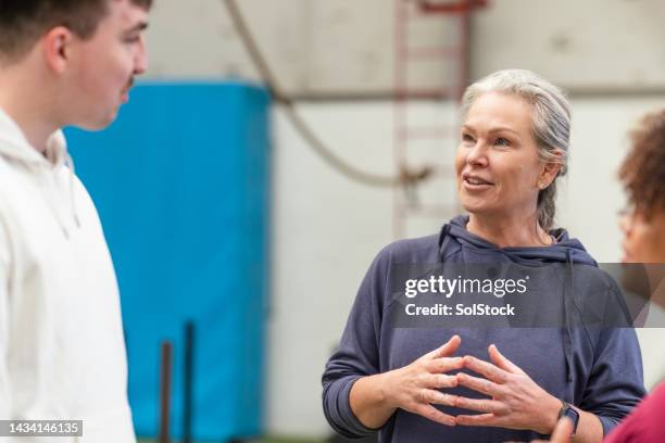 discussing their training exercises - sport coach united kingdom stock pictures, royalty-free photos & images