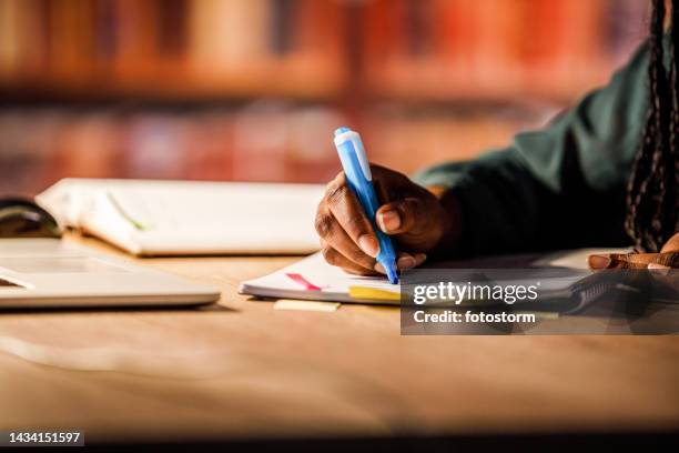 close-up shot of a student highlight notes while studying for exam - school book stock pictures, royalty-free photos & images