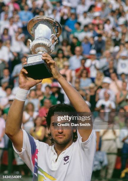 Alberto Mancini from Argentina holds aloft the Federazione Italiana Tennis Trophy after winning the Men's Singles Final match against Andre Agassi of...