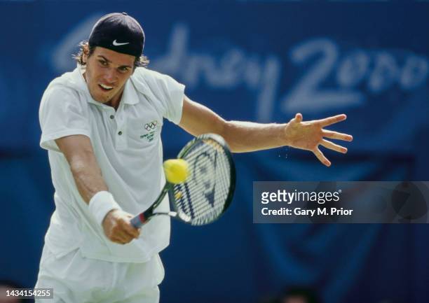 Tommy Haas of Germany plays a backhand return to Yevgeny Kafelnikov of Russia during their Men's Singles Final match at the XXVII Summer Olympic...