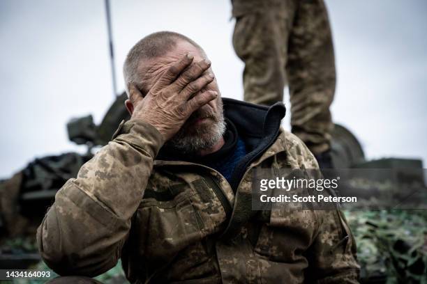 Ukrainian soldier with the nickname Dragon shows the fatigue of months of fighting without a break, as the rest of the tank crew make adjustments to...