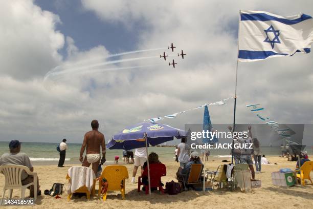 Israeli gather on the beach in the Mediterranean city of Tel Aviv to watch a military show marking Israeli Independence Day on April 26 the 64the...