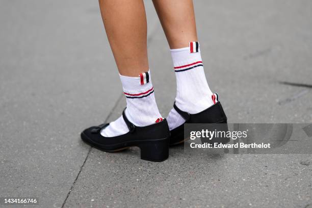 Kiwi Lee Han wears white socks from Thom Browne, black shiny satin ballerinas from Thom Browne, outside Thom Browne, Paris Fashion Week - Womenswear...