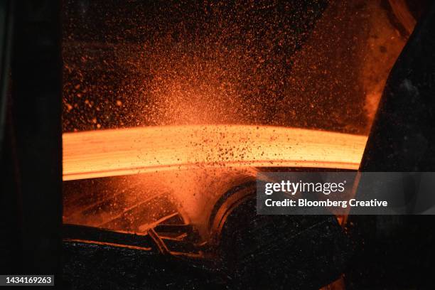 a red hot steel slab - iron roll stockfoto's en -beelden