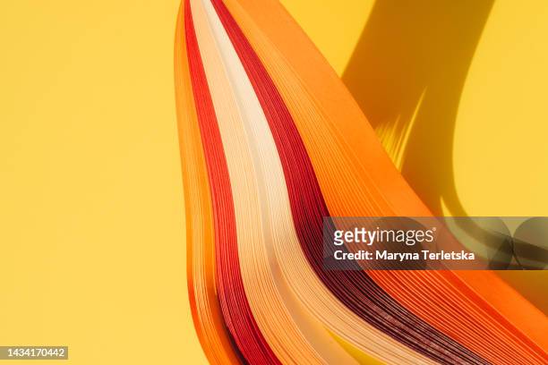 abstract background with multicolored stripes of paper. background with quilling. - orange silk background stock-fotos und bilder