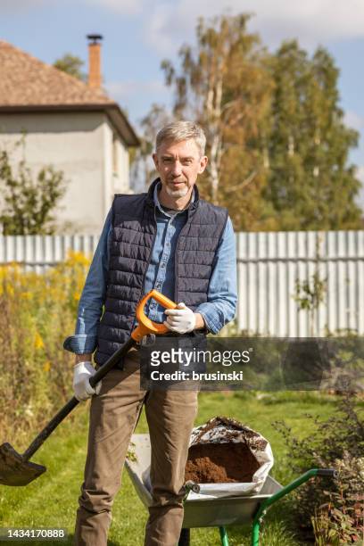 portrait of a 50 year old white bearded man working in his own garden - one mature man only stock pictures, royalty-free photos & images