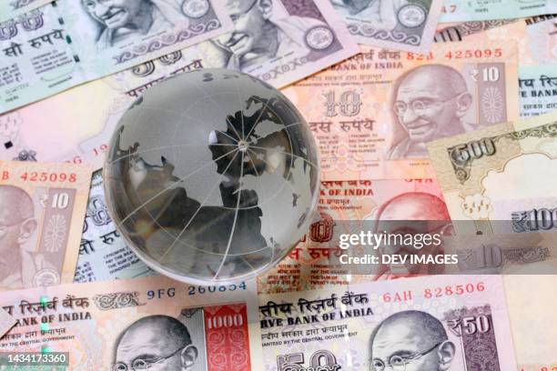 glass globe on indian currency notes - gandhi stock-fotos und bilder