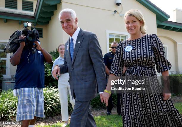 Charlie Crist, the Democratic gubernatorial candidate for Florida, walks with his fiancee Chelsea Grimes during a campaign stop at the Evelyn Greer...