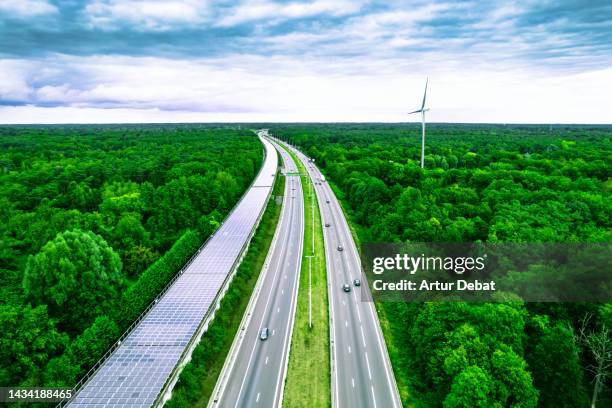 aerial view of a green highway and railway tunnel covered with solar panels in belgium. - antwerpen belgien bildbanksfoton och bilder