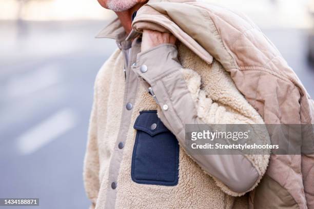 Stylist Bert Sterck wearing a beige jacket by Rag & Bone, all by loui.rocks during a street style shooting on October 17, 2022 in Dusseldorf, Germany.