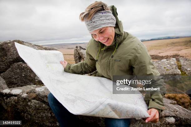 girl checks location on map on dartmoor - dartmoor map stock pictures, royalty-free photos & images