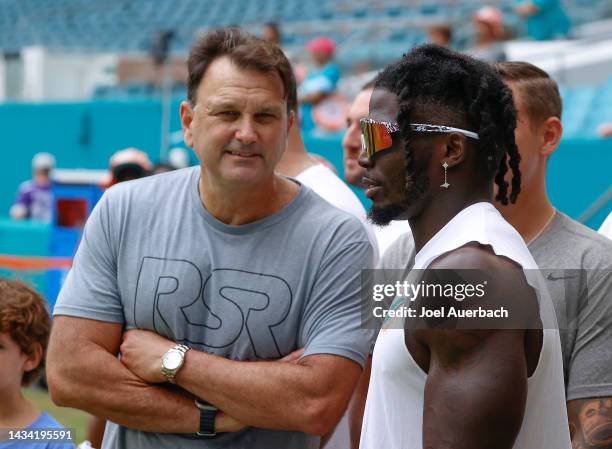 Tyreek Hill of the Miami Dolphins talks to American sports agent Drew Rosenhaus prior to the game against Minnesota Vikings at Hard Rock Stadium on...