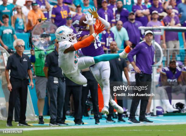 Noah Igbinoghene of the Miami Dolphins and Adam Thielen of the Minnesota Vikings battle for the ball at Hard Rock Stadium on October 16, 2022 in...