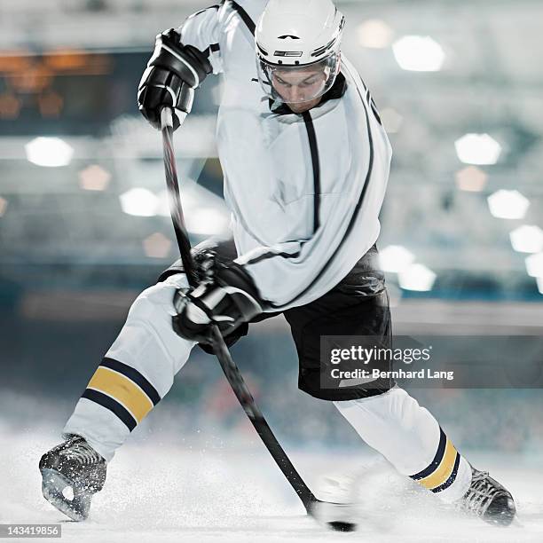 ice hockey player shooting puck - hockey rink stock pictures, royalty-free photos & images