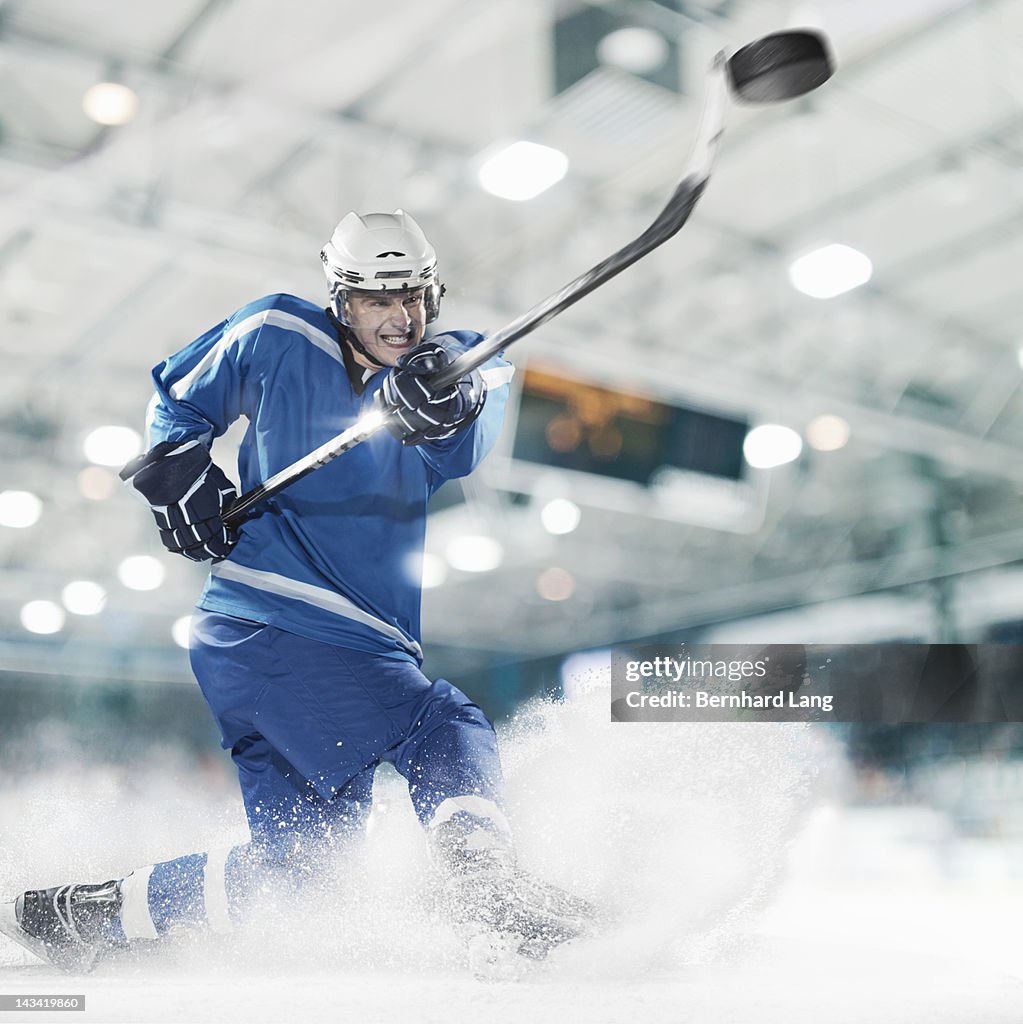 Ice hockey player shooting puck