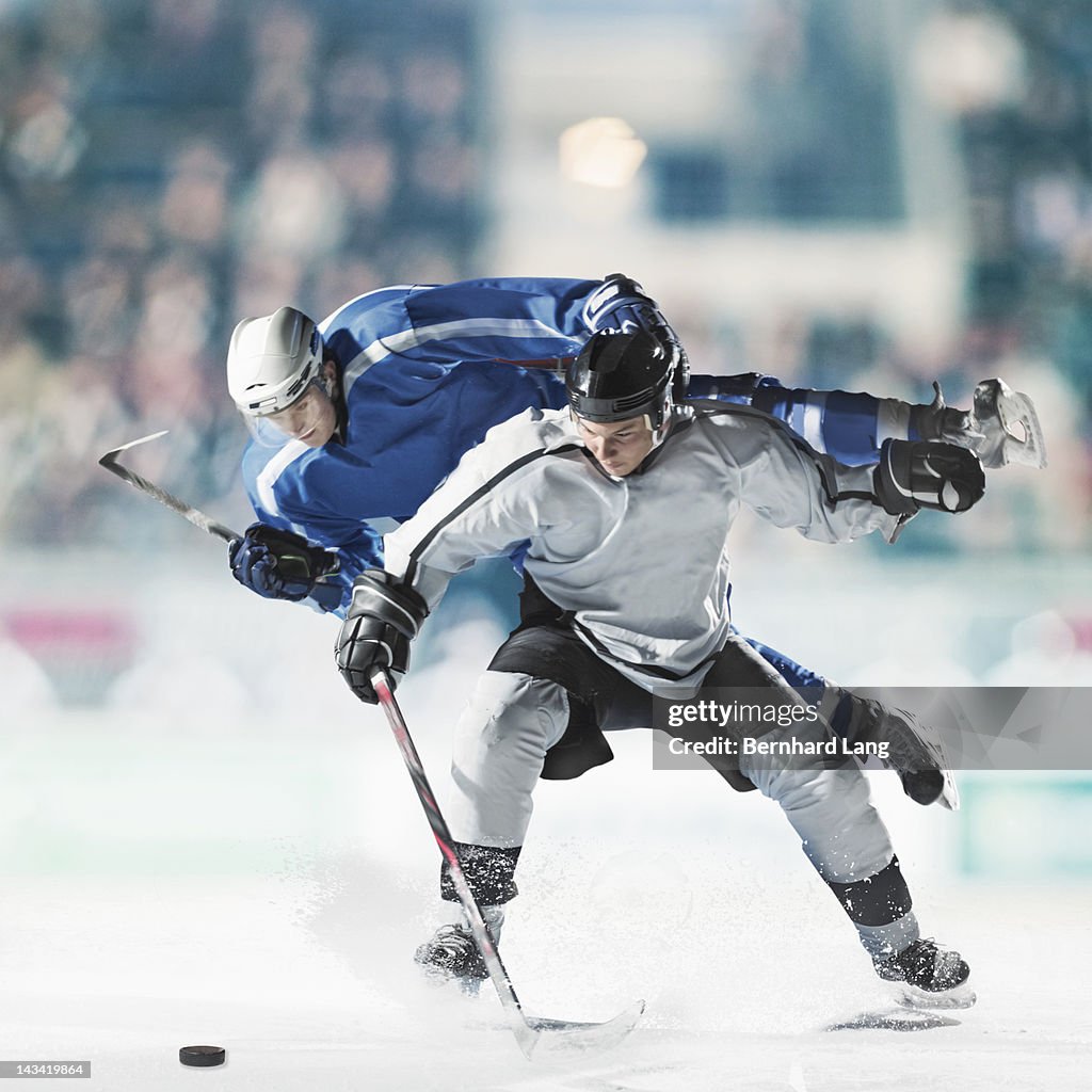 Ice hockey players fighting for puck