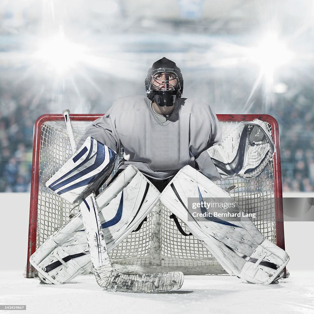 Ice hockey goal keeper in front of goal