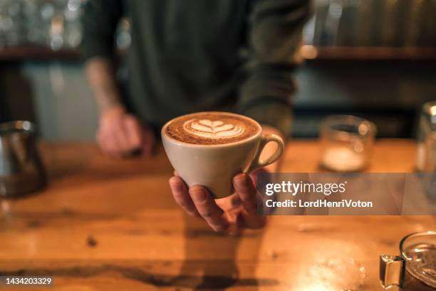 barista holding a cup of espresso coffee - cafeteria counter stock pictures, royalty-free photos & images