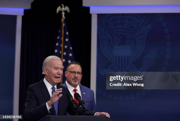 President Joe Biden speaks on the student debt relief plan as Secretary of Education Miguel Cardona listens in the South Court Auditorium at the...