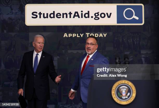 President Joe Biden and Secretary of Education Miguel Cardona leave after Biden spoke on the student debt relief at the South Court Auditorium at...