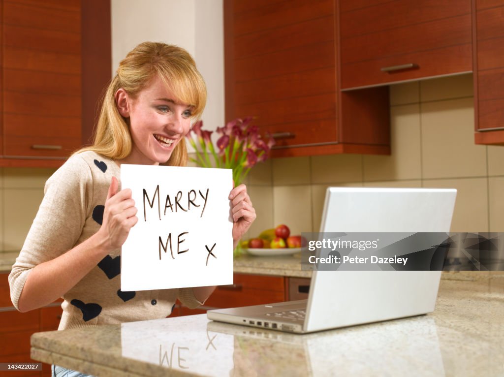 Young woman on the internet with marry me sign