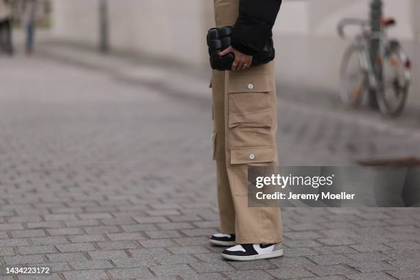 Carolin Niemczyk wearing Nike Air Jordan beige high top sneaker and The Frankie Shop beige pants on October 15, 2022 in Berlin, Germany.