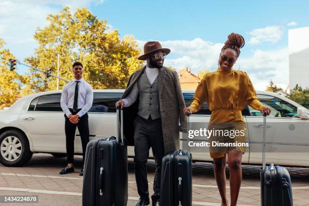 wealthy couple leaving limousine. - limousine exterior stock pictures, royalty-free photos & images