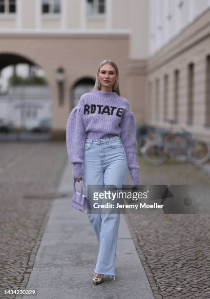 Carolin Niemczyk wearing Rotate lilac knit logo sweater, Jacquemus lilac bag, Gina Tricot wide leg baby blue denim jeans and Amina Muaddi green...