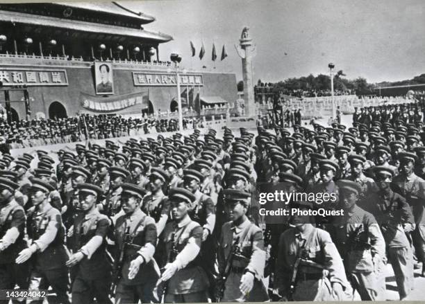 In celebration of the first anniversary of the Communist Chinese government, a parade of the Red Chinese army passes in review before the dais where...