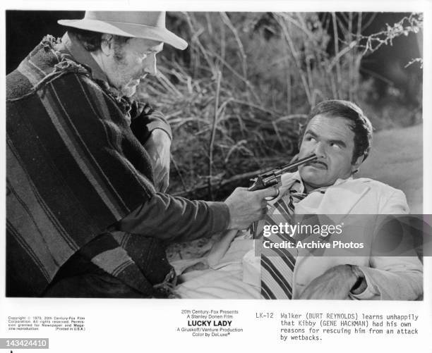 Gene Hackman points gun at the nose of Burt Reynolds in a scene from the film 'Lucky Lady', 1975.