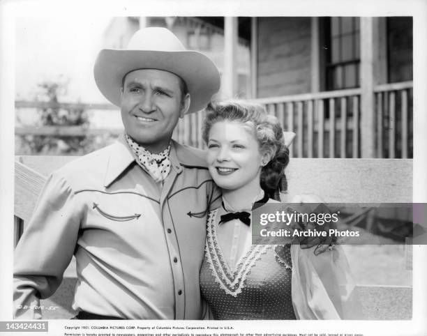 Gene Autry with his arm around Gail Davis in a scene from the film 'Valley Of Fire', 1951.