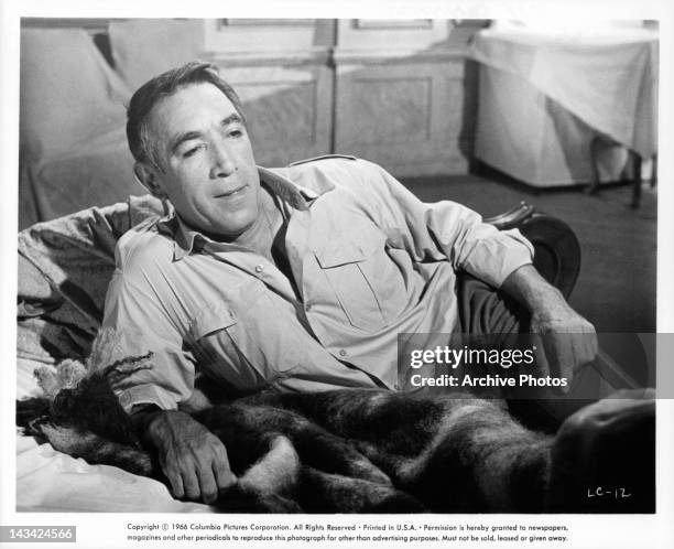 Anthony Quinn relaxing on couch in a scene from the film 'Lost Command', 1966.