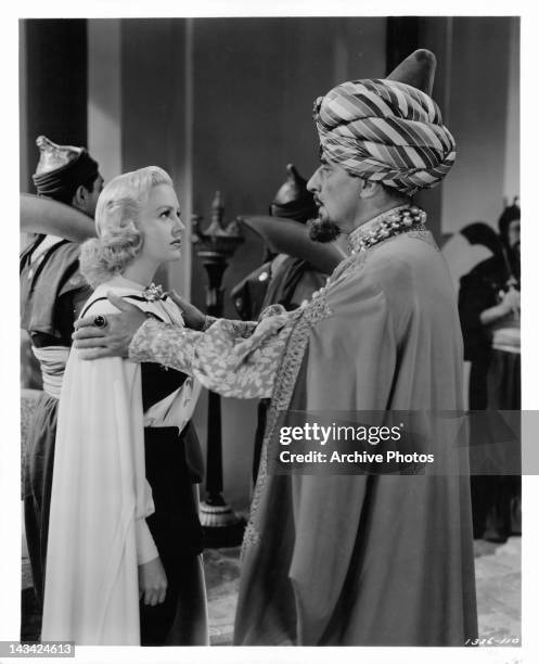 Douglass Dumbrille tells Marilyn Maxwell to look into his eyes in a scene from the film 'Lost In A Harem', 1944.