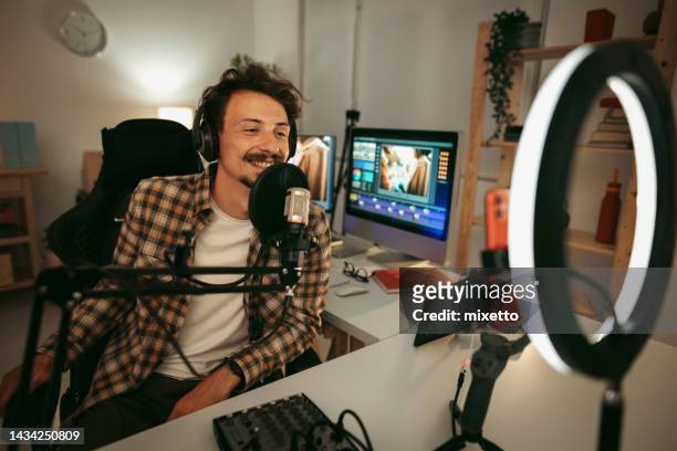 laughing man host streaming podcast in studio - radio host stock pictures, royalty-free photos & images