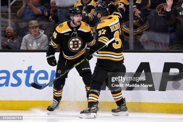 Jake DeBrusk of the Boston Bruins celebreates with Patrice Bergeron after scoring a goal against the Florida Panthers during the first period at TD...