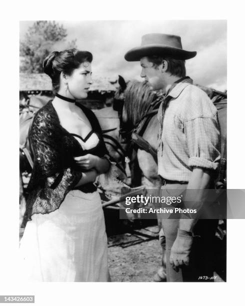 Irene Papas talking to Don Dubbins outside in a scene from the film 'Tribute To A Bad Man', 1956.