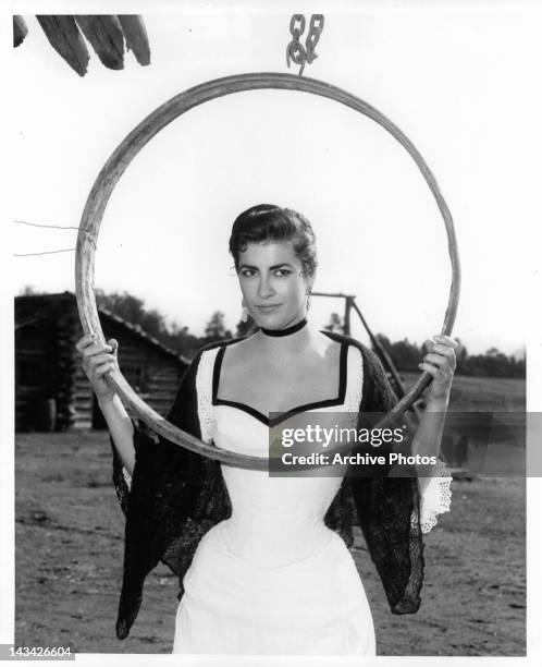 Irene Papas holding large hanging ring on location for the film 'Tribute To A Bad Man', 1956.