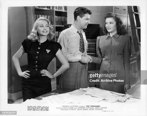 Adele Mara with hands to her hips as Grant Withers shakes hand of Janet Martin in a scene from the film 'The Trespasser', 1947.