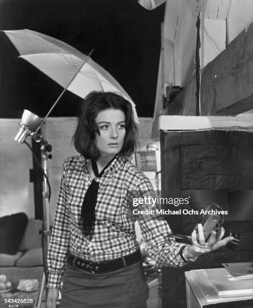 Vanessa Redgrave holding a camera in a scene from the film 'Blow Up', 1966.