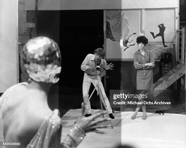 David Hemmings directs the pose of a model in a scene from the film 'Blow Up', 1966.