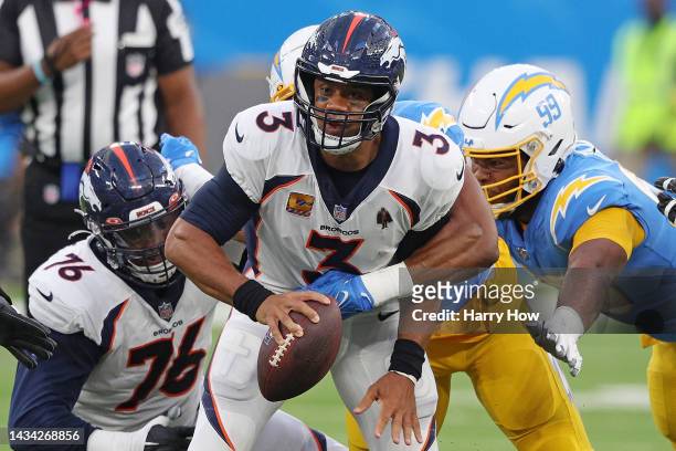 Russell Wilson of the Denver Broncos is sacked by Khalil Mack of the Los Angeles Chargers during the first quarter at SoFi Stadium on October 17,...