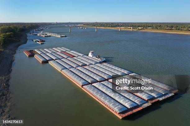 In this aerial, barges are tied up along the bank of the Ohio River at the confluence of the Mississippi River on October 17, 2022 in Cairo,...