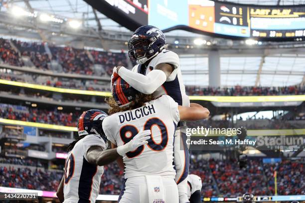 Courtland Sutton and Jerry Jeudy of the Denver Broncos celebrates a touchdown by Greg Dulcich against the Los Angeles Chargers during the first half...