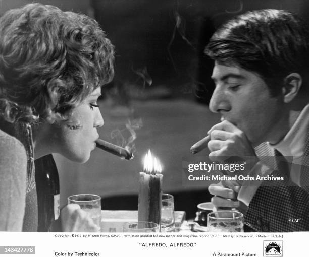 Carla Gravina and Dustin Hoffman enjoy an unusual after dinner smoke in a scene from the film 'Alfredo, Alfredo', 1972.