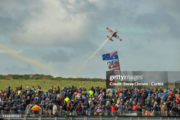 The Red Bull stunt plane flys over fans during the MotoGP of Australia at Phillip Island Grand Prix Circuit on October 16, 2022 in Phillip Island,...