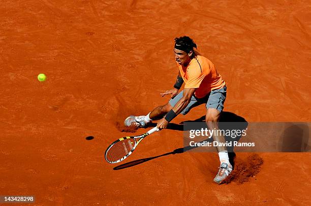 Rafael Nadal of Spain returns the ball to Roberto Farah of Colombia during their match on day 4 of the ATP 500 World Tour Barcelona Open Banco...