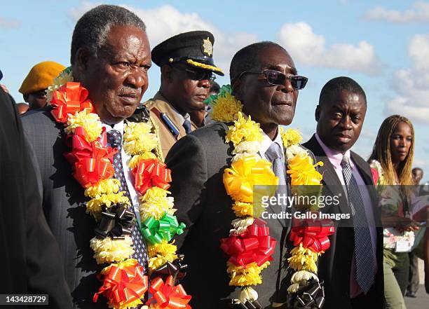 Zambian President Michael Sata is welcomed by Zimbabwean President Robert Mugabe at the Harare International Airport on April 25, 2012 in Harare,...
