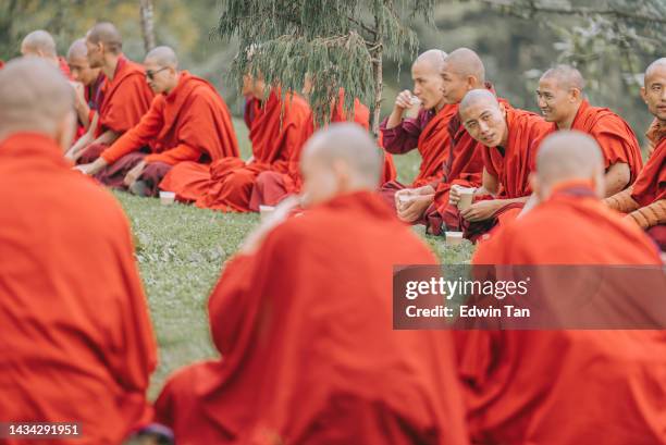 bhutanese monks lunch break beside dochula pass on october 7th year 2022 - tibetansk buddhism bildbanksfoton och bilder