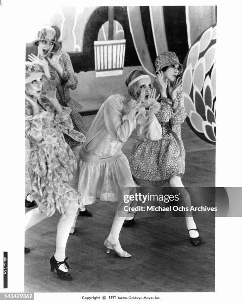 Twiggy, surrounded by Georgina Hale, Sally Bryant and Caryl Little as they sing and dance in a scene from the film 'The Boy Friend', 1971.